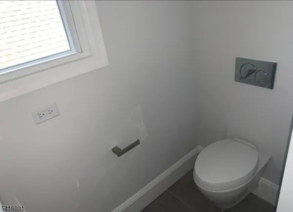 a white toilet sitting next to a window