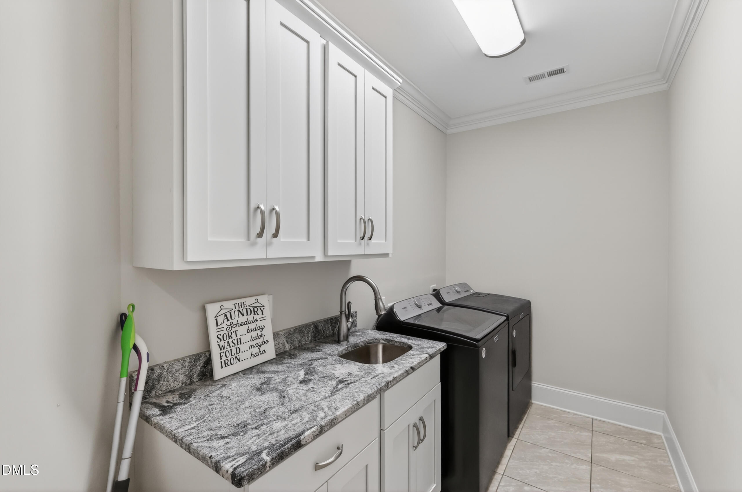 261 Character Drive Rolesville, NC 27571 - Photo 42 of 77 a kitchen with granite countertop a sink a stove and cabinets