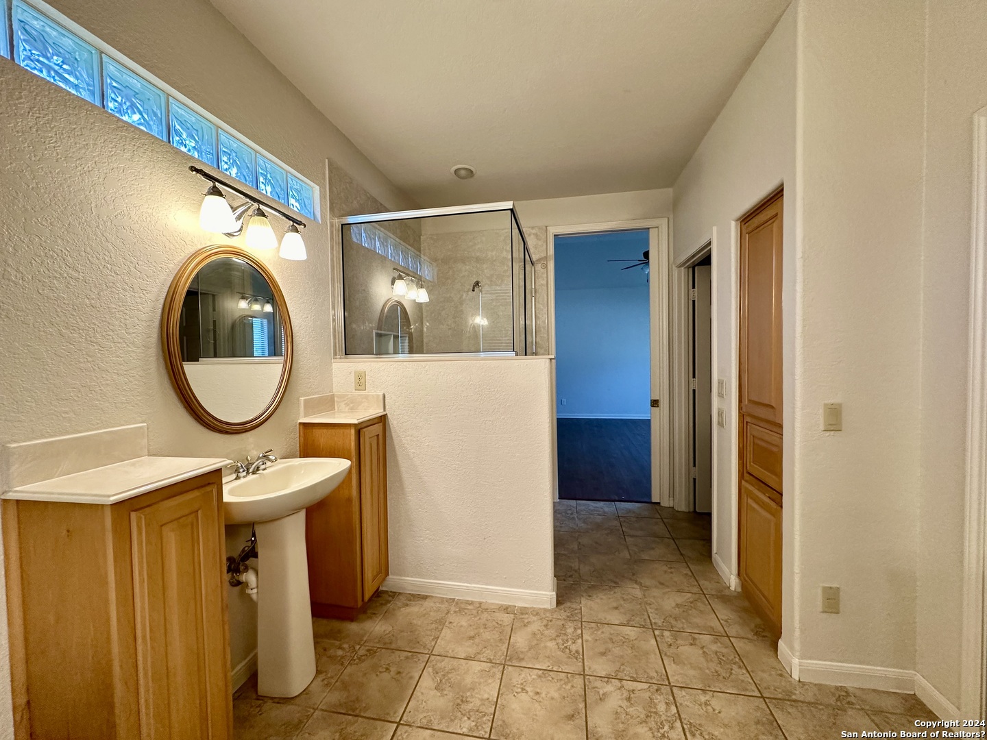 23107 Osprey Ridge San Antonio, TX 78258 - Photo 23 of 28 a view of a bathroom with a sink and mirror