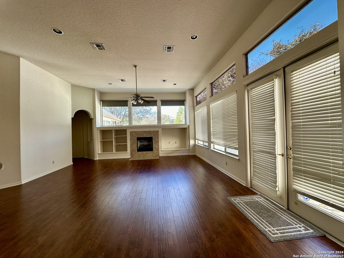 23107 Osprey Ridge San Antonio, TX 78258 - Photo 5 of 28 a view of an empty room with wooden floor and a window