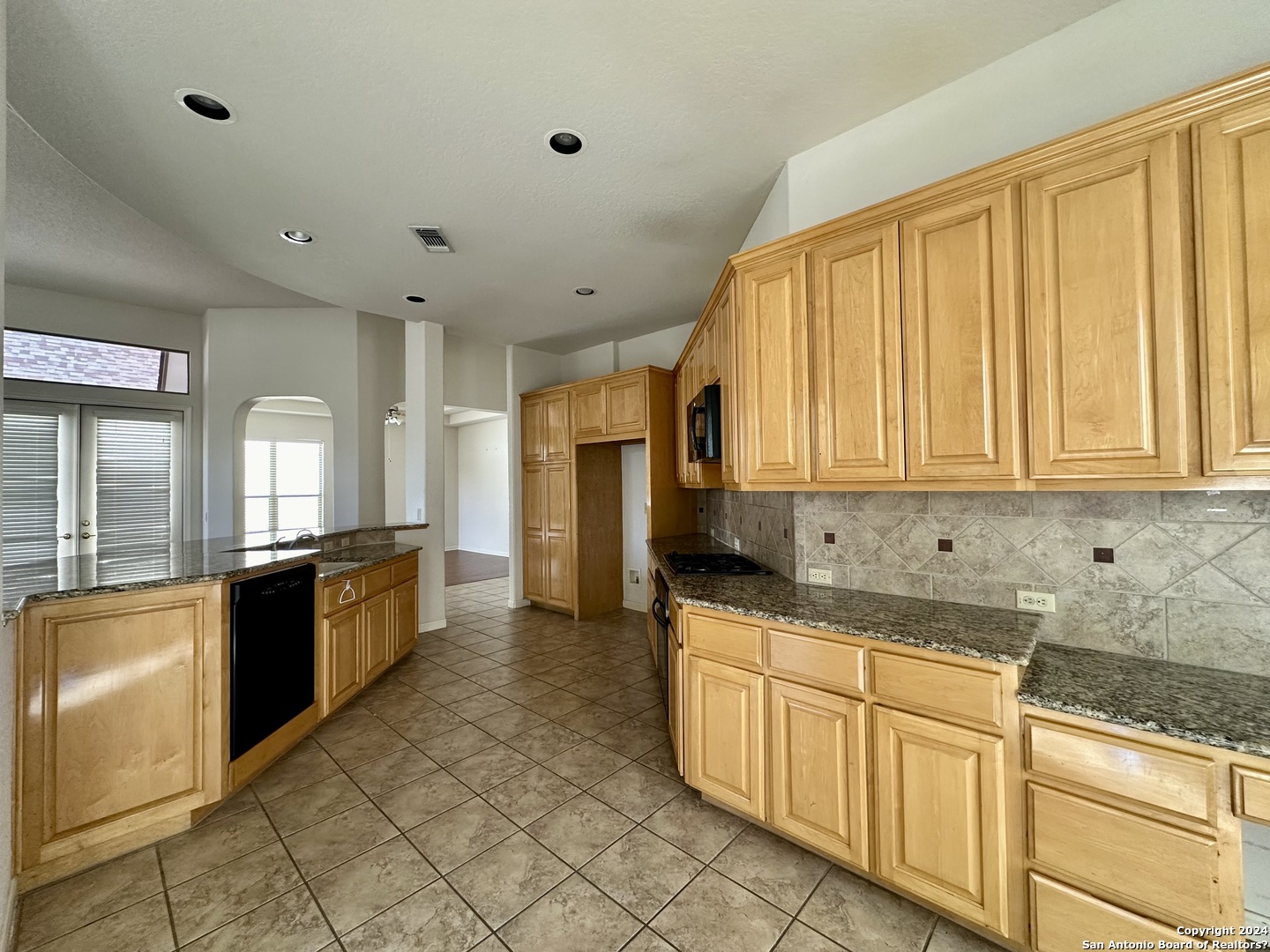 23107 Osprey Ridge San Antonio, TX 78258 - Photo 7 of 28 a kitchen with stainless steel appliances granite countertop a stove a sink and a granite counter tops