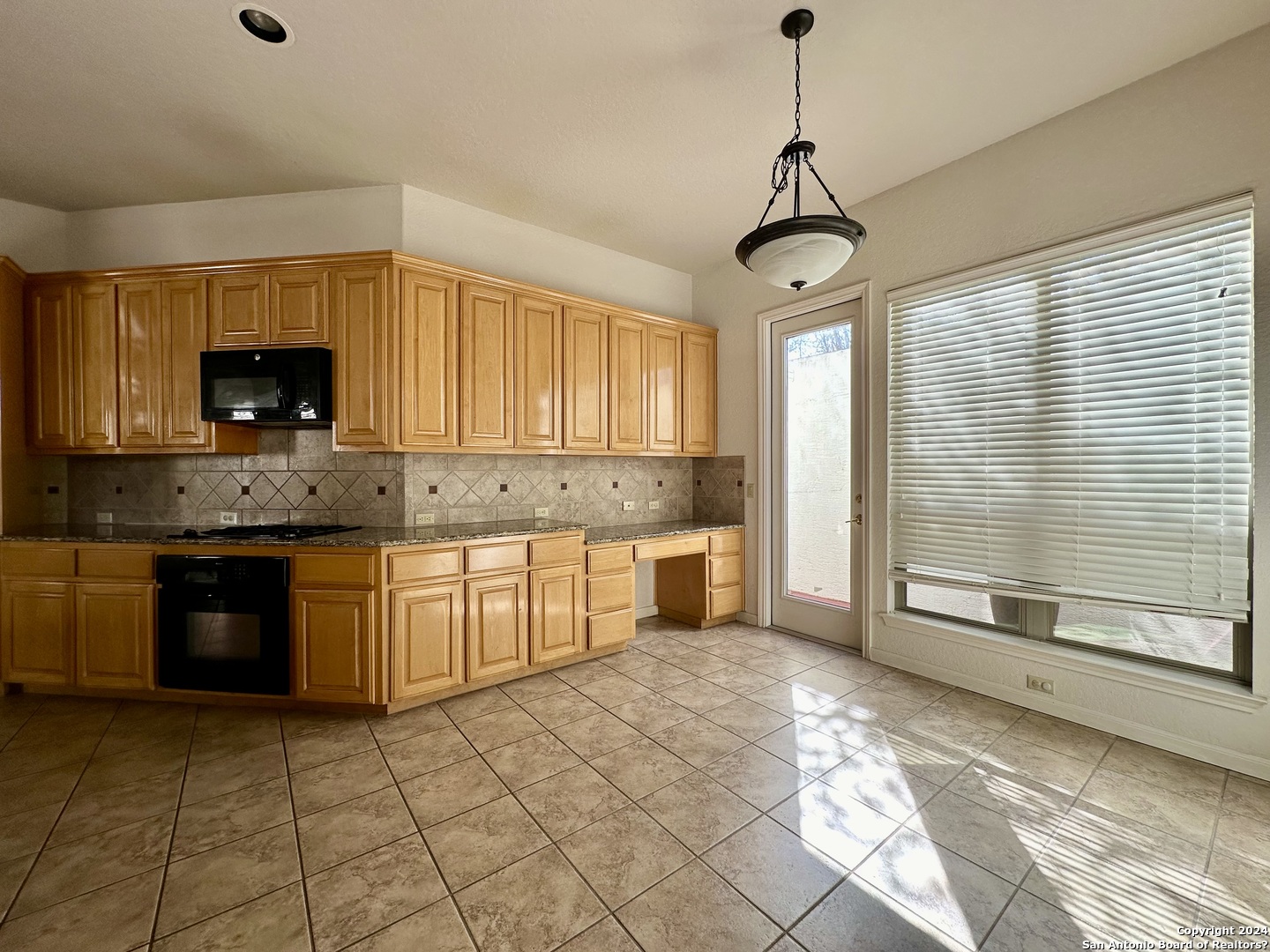 23107 Osprey Ridge San Antonio, TX 78258 - Photo 9 of 28 a kitchen with stainless steel appliances granite countertop a stove a sink and a granite counter tops
