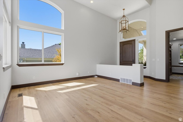 12317 Cypress Point Way Draper, UT 84020 - Photo 6 of 41 Two-story great room featuring wood-finish flooring, a grand arched window, and a prominent entryway with a dark wood door