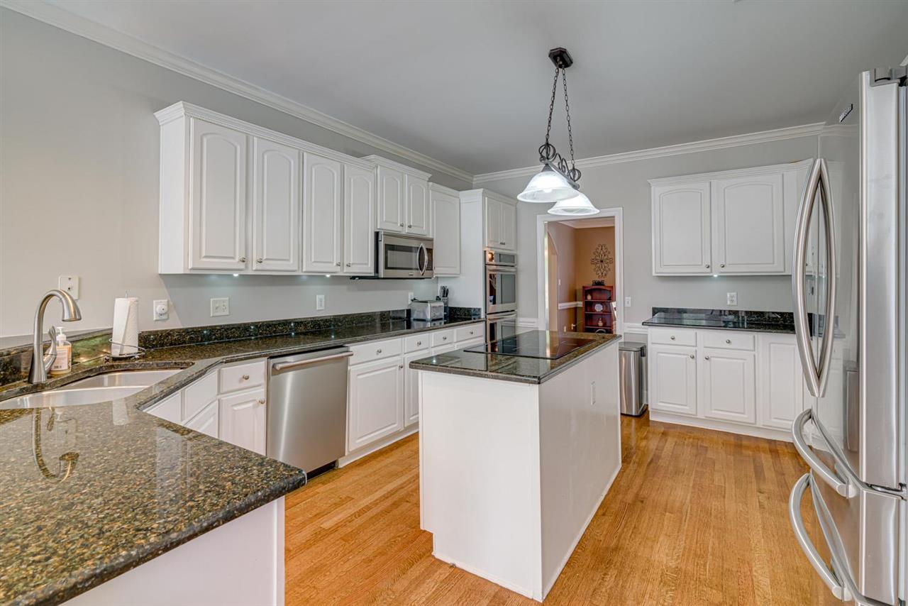 1344 Wahkin Road Collierville, TN 38017 - Photo 11 of 25 a kitchen with granite countertop a sink a counter top space appliances and cabinets
