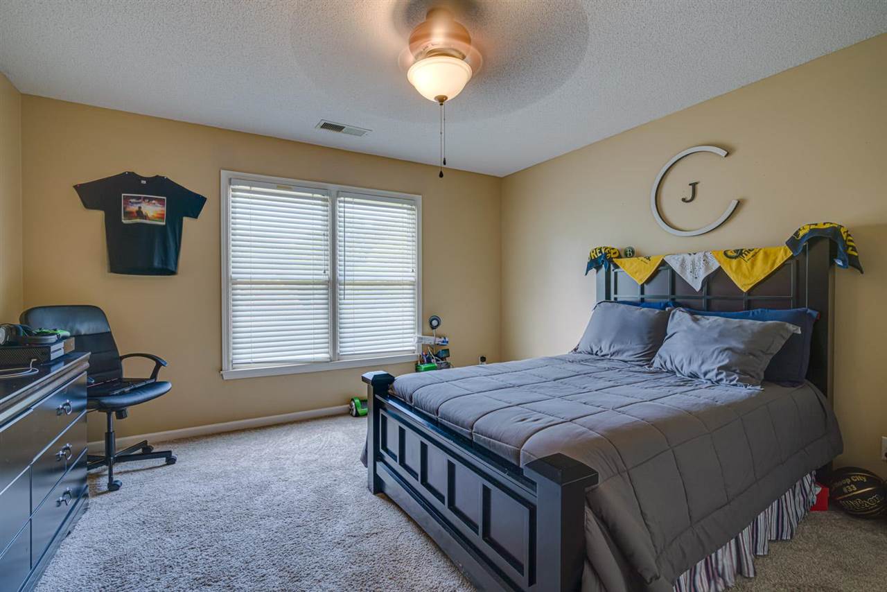 1344 Wahkin Road Collierville, TN 38017 - Photo 18 of 25 a bedroom with a bed and a chandelier