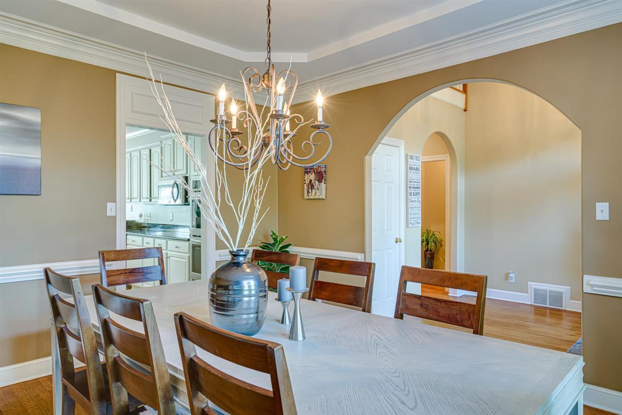 1344 Wahkin Road Collierville, TN 38017 - Photo 3 of 25 a view of a dining room with furniture a chandelier and wooden floor