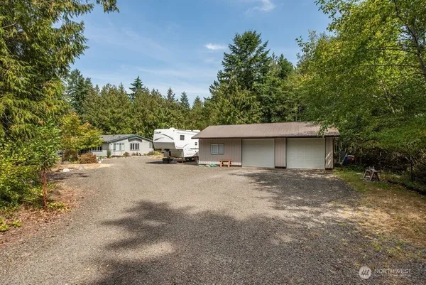 a view of a house with a yard and garage