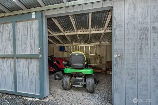 a view of a chair and table in the back yard of the house