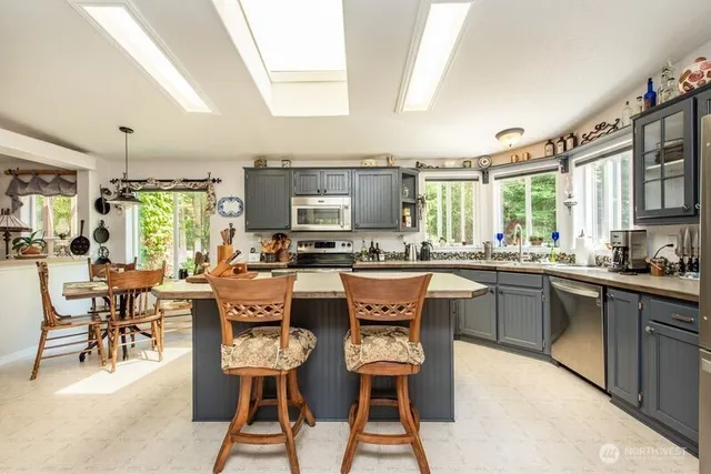 a large kitchen with a table and chairs