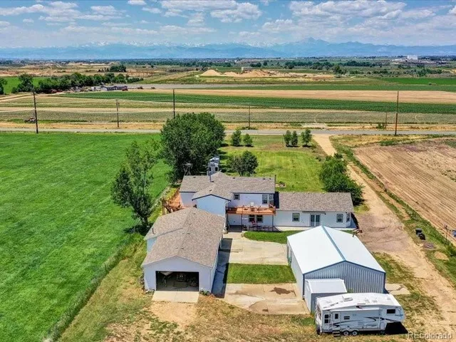 an aerial view of a house with garden space and outdoor seating