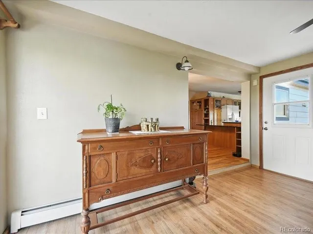 a dining room with furniture window and wooden floor