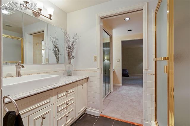 34 Upland Road Colorado Springs, CO 80906 - Photo 16 of 34 Jack 'n Jill bathroom and closets between two bedrooms on the main floor - new floors, counters, vanities, toilet