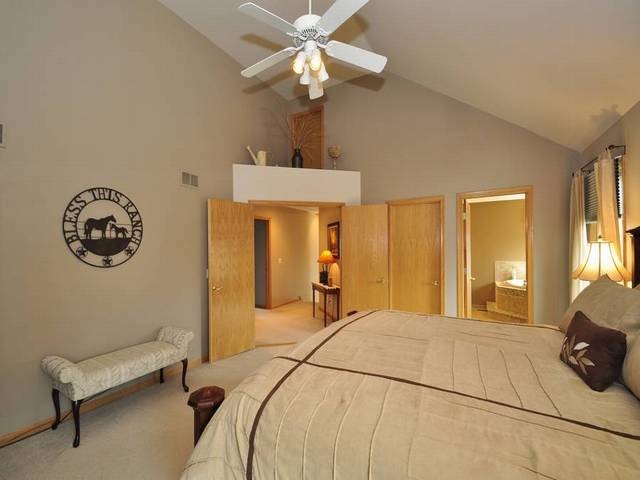 1603 Beech Street Spring Grove, IL 60081 - Photo 13 of 24 a bedroom with a bed and a chandelier