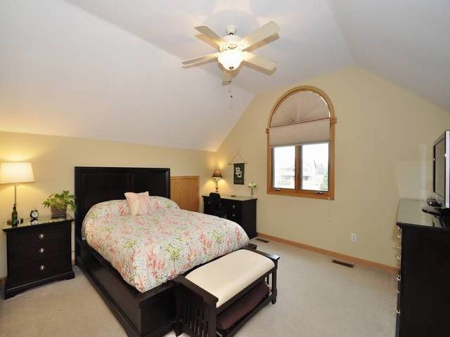 1603 Beech Street Spring Grove, IL 60081 - Photo 15 of 24 a bedroom with a large bed and a chandelier