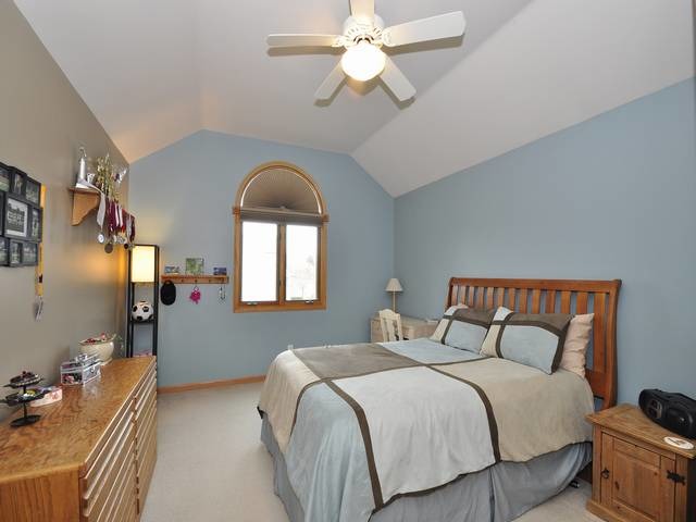 1603 Beech Street Spring Grove, IL 60081 - Photo 18 of 24 a bedroom with a bed and a chandelier