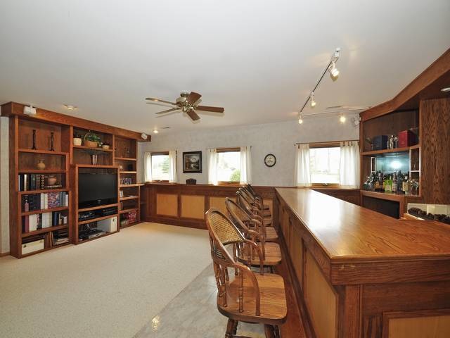 1603 Beech Street Spring Grove, IL 60081 - Photo 20 of 24 a living room with furniture a flat screen tv and a table