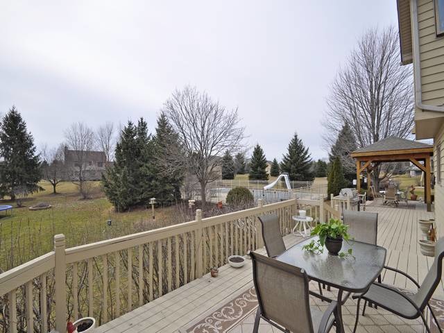 1603 Beech Street Spring Grove, IL 60081 - Photo 24 of 24 a view of balcony with furniture and trees in the background