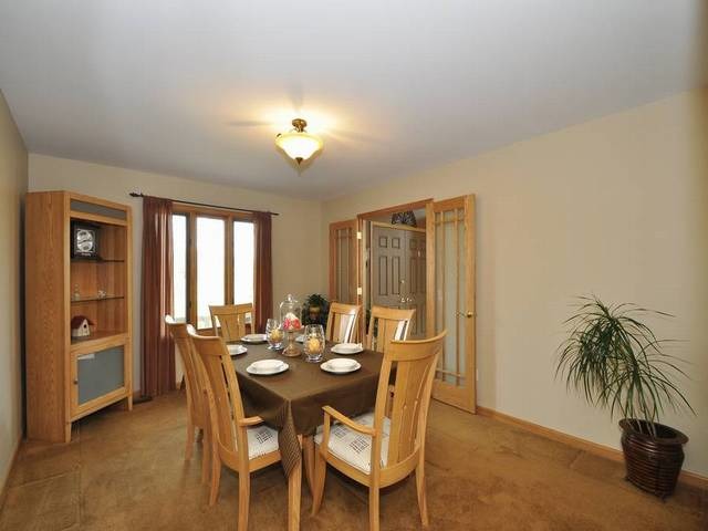 1603 Beech Street Spring Grove, IL 60081 - Photo 6 of 24 a view of a dining room with furniture and a potted plant