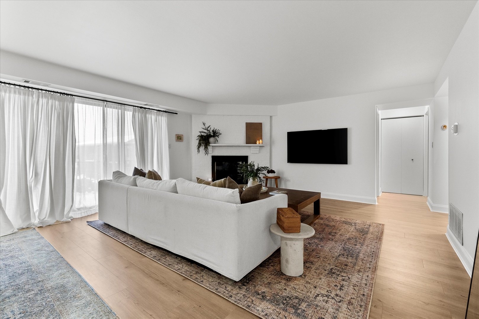 9051 South Roberts Road, Unit 310 Hickory Hills, IL 60457 - Photo 3 of 19 a living room with furniture a flat screen tv and a fireplace