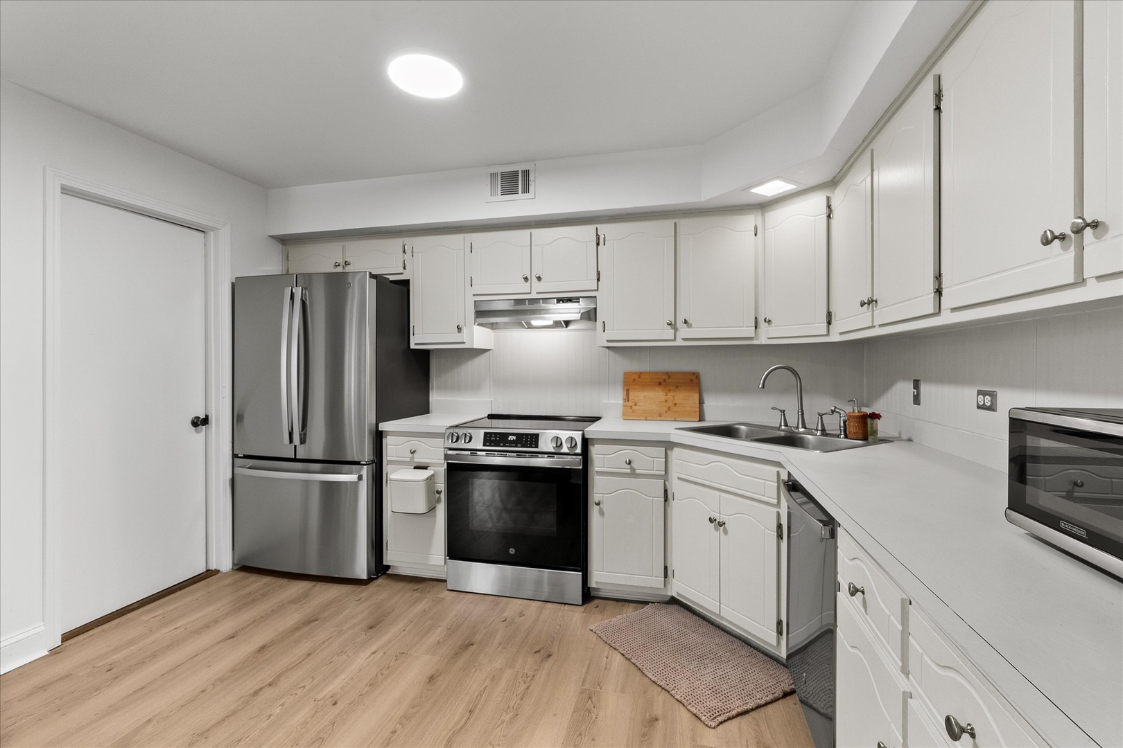 9051 South Roberts Road, Unit 310 Hickory Hills, IL 60457 - Photo 7 of 19 a kitchen with stainless steel appliances granite countertop a refrigerator stove and white cabinets