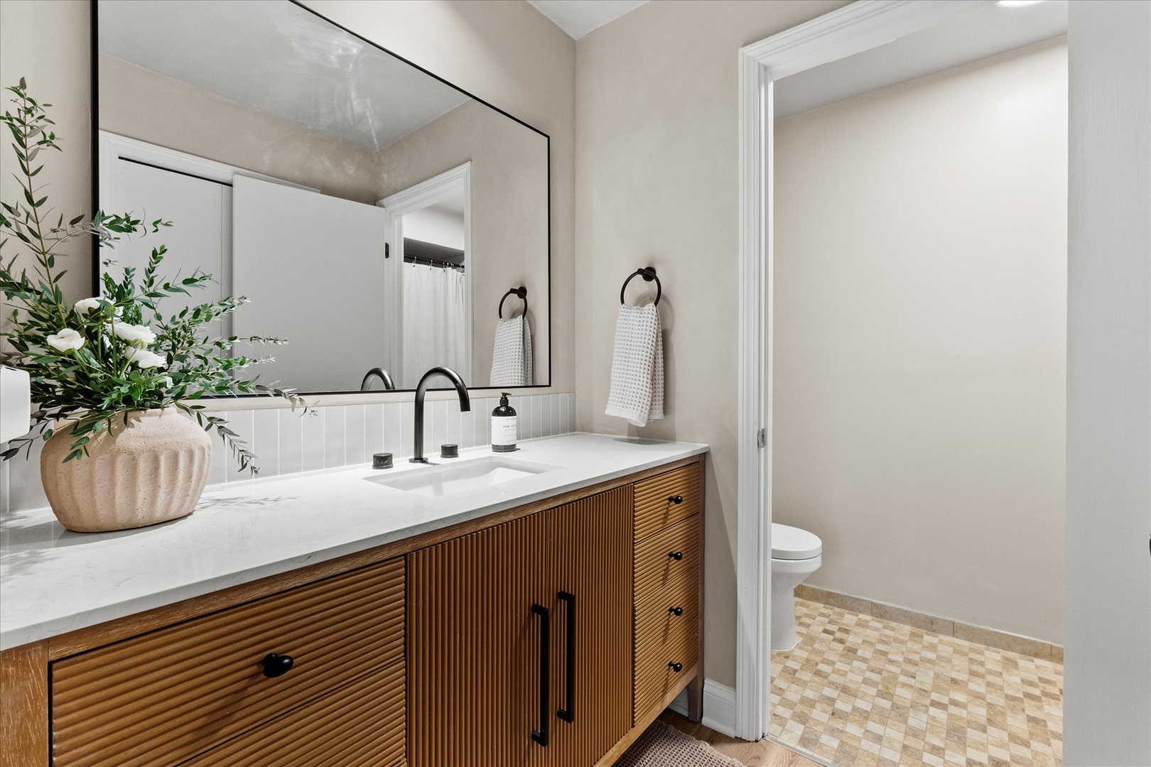 9051 South Roberts Road, Unit 310 Hickory Hills, IL 60457 - Photo 9 of 19 a bathroom with a sink a toilet and a mirror