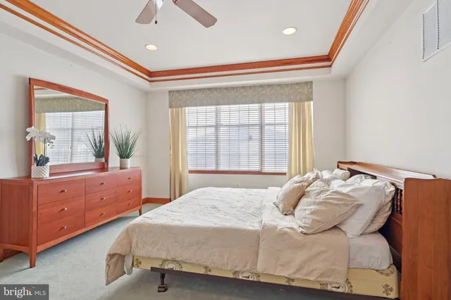 a bedroom with a bed couch and window