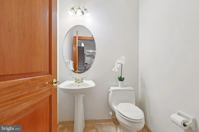 a spacious bathroom with a granite countertop sink and a mirror