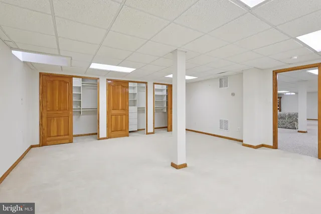 a living room with furniture cabinets and window