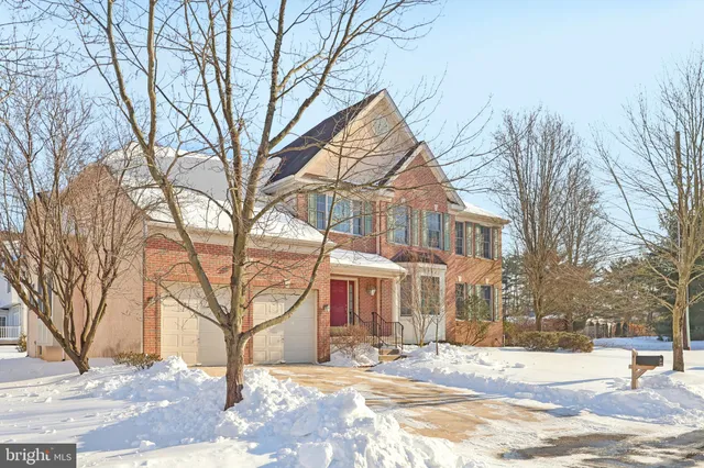 a view of a house with a yard covered in snow