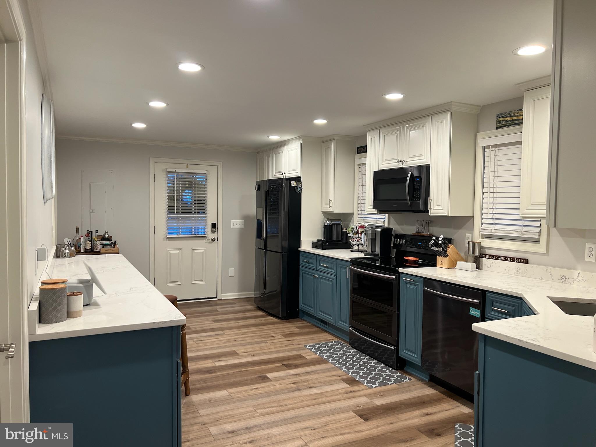 1890 Locust Road Pasadena, MD 21122 - Photo 12 of 53 a kitchen with cabinets and stainless steel appliances