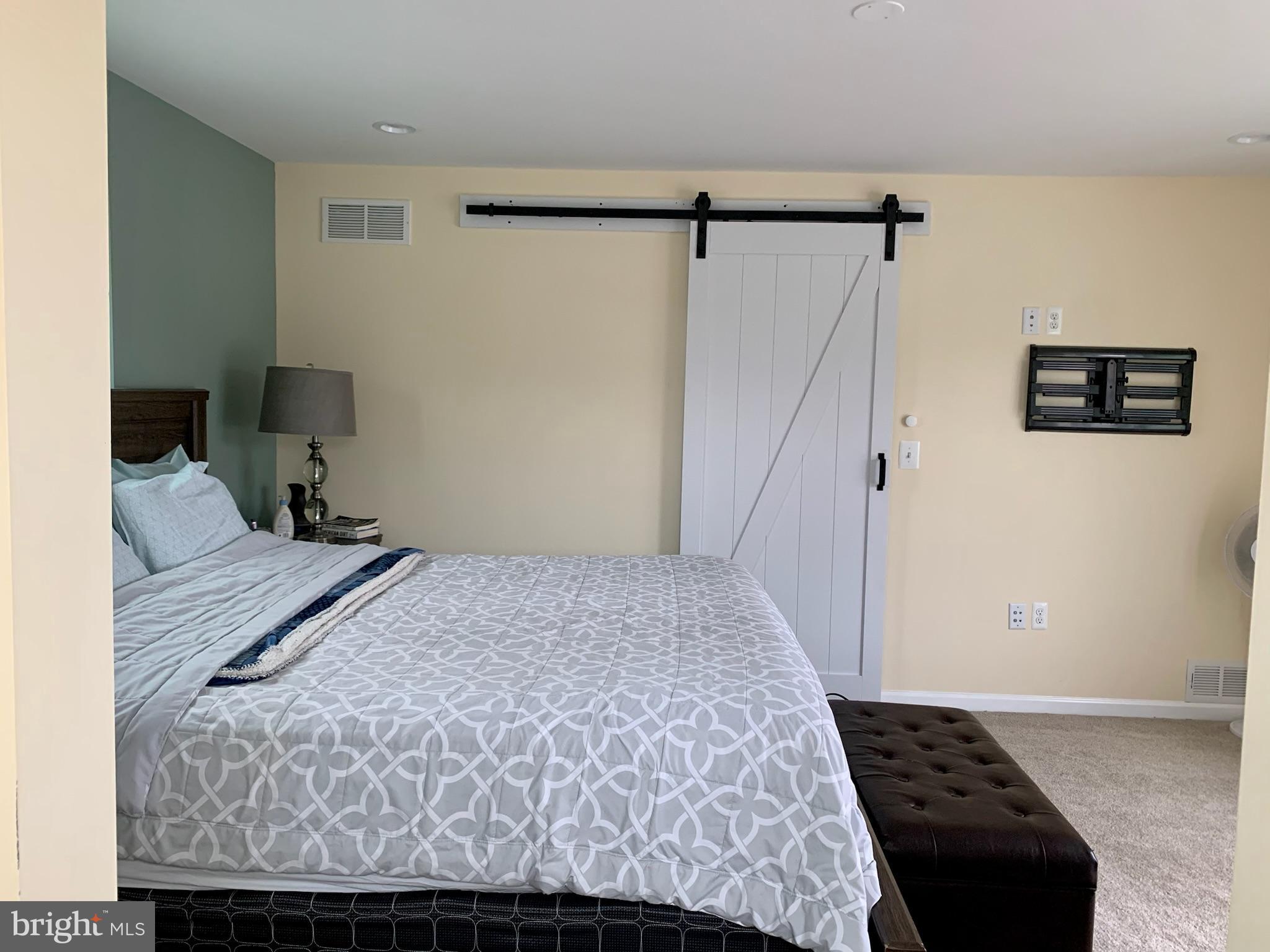 1890 Locust Road Pasadena, MD 21122 - Photo 20 of 53 a bedroom with a bed and a walk in closet