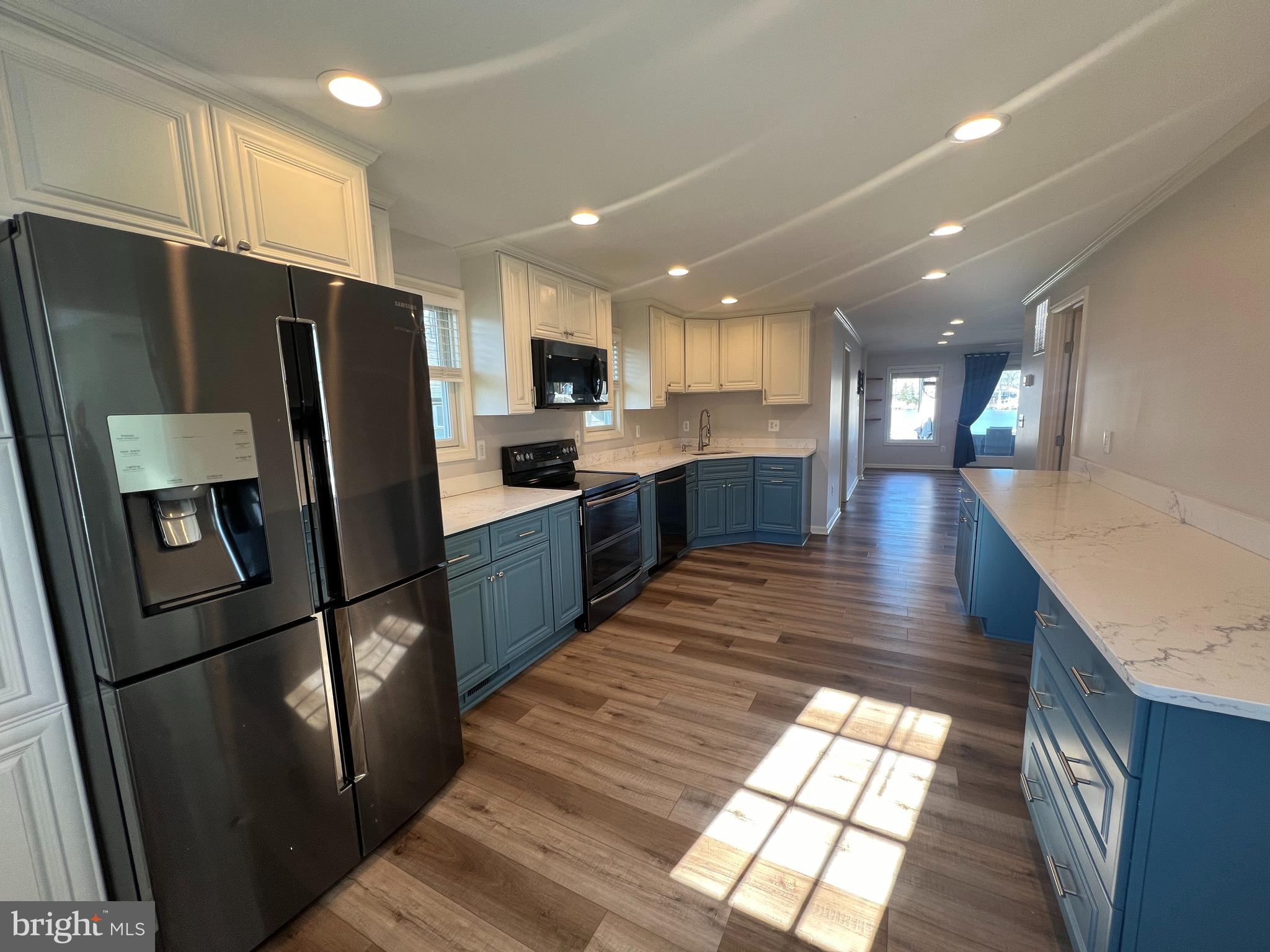 1890 Locust Road Pasadena, MD 21122 - Photo 45 of 53 a kitchen with stainless steel appliances granite countertop refrigerator sink microwave and stove