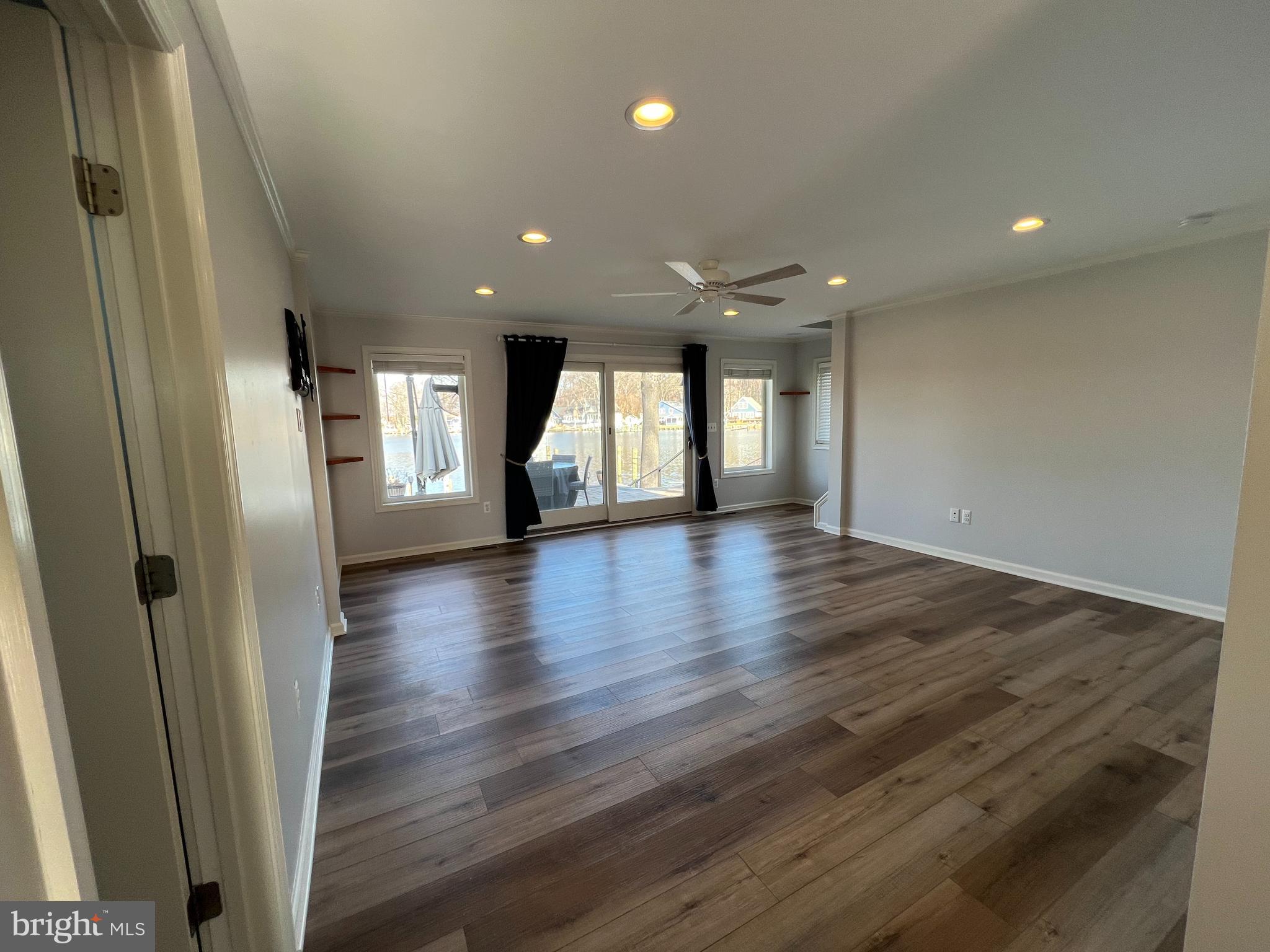 1890 Locust Road Pasadena, MD 21122 - Photo 49 of 53 an empty room with wooden floor and windows