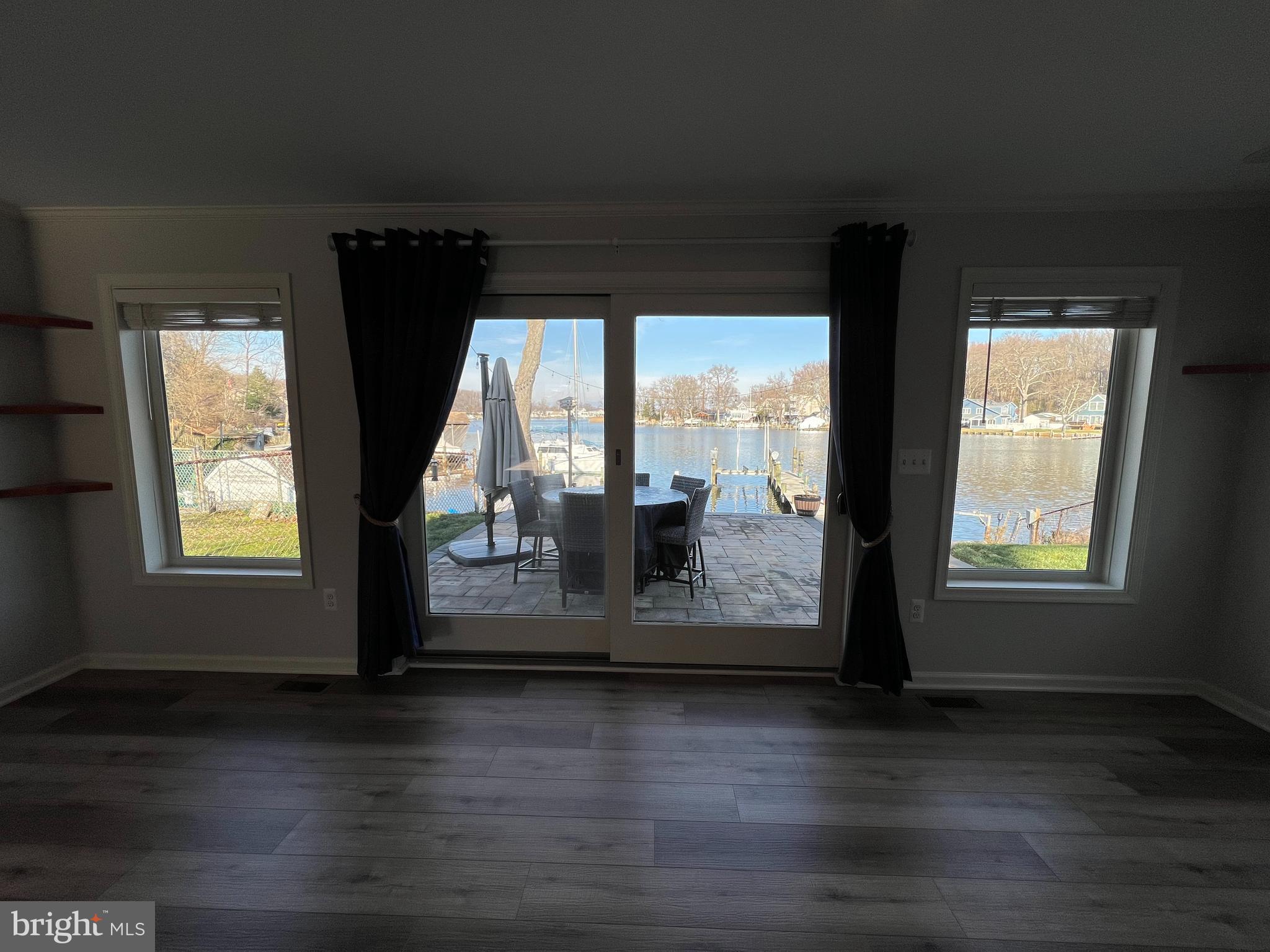 1890 Locust Road Pasadena, MD 21122 - Photo 52 of 53 a view of empty room with wooden floor and fan