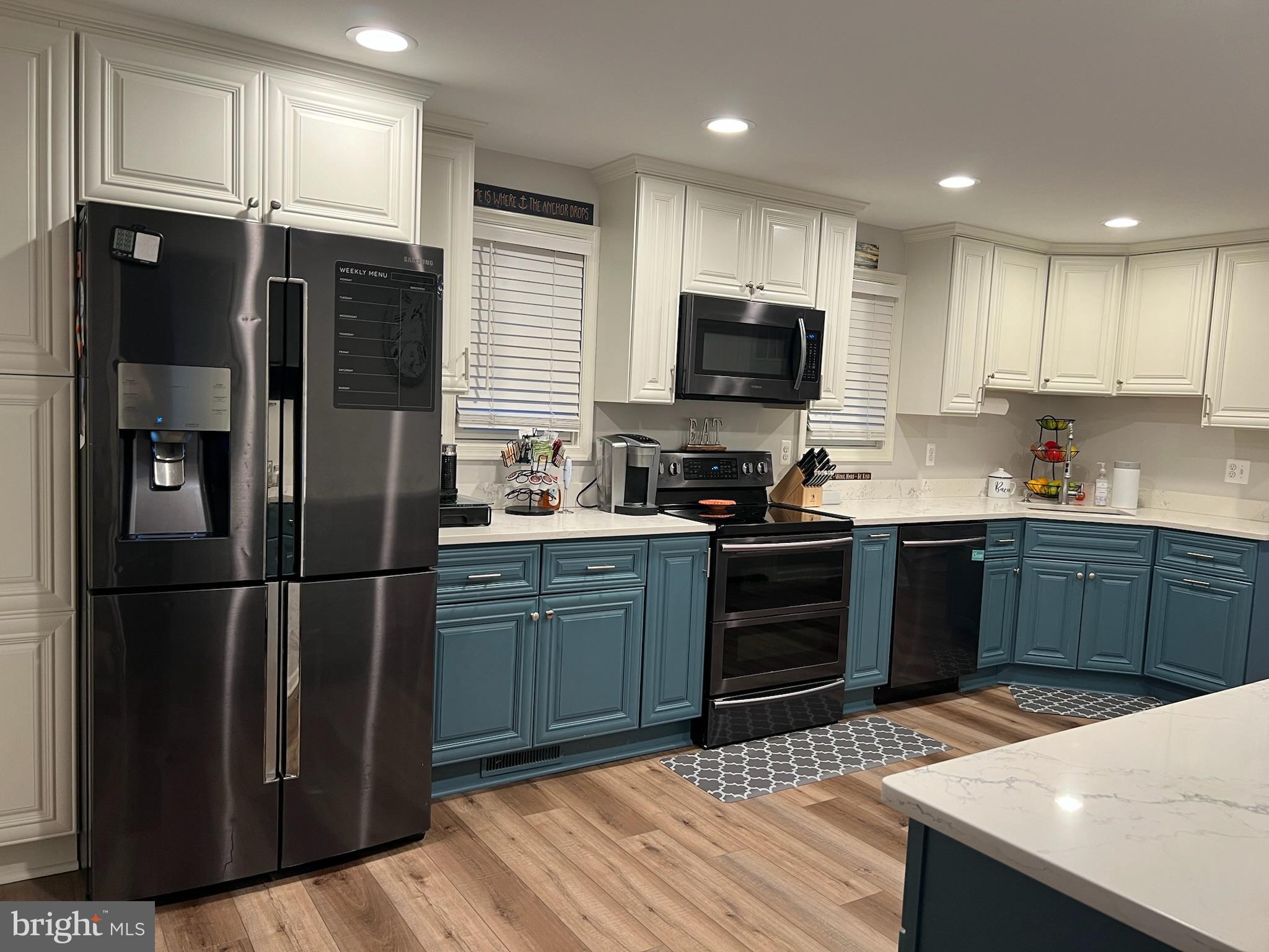 1890 Locust Road Pasadena, MD 21122 - Photo 10 of 53 a kitchen with stainless steel appliances kitchen island granite countertop a refrigerator stove and microwave