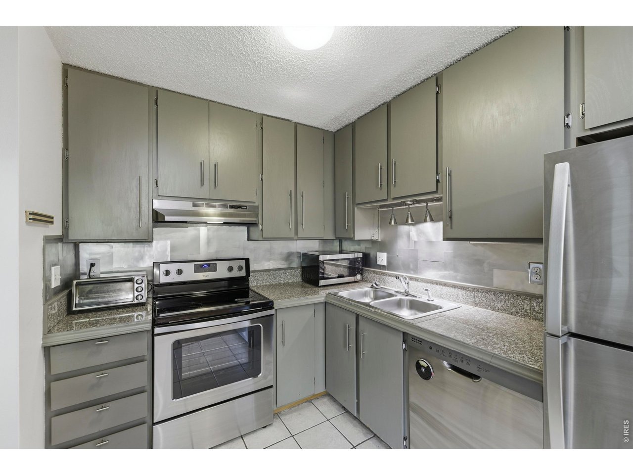 925 Columbia Road, Unit 824 Fort Collins, CO 80525 - Photo 11 of 36 a kitchen with a sink stove and refrigerator