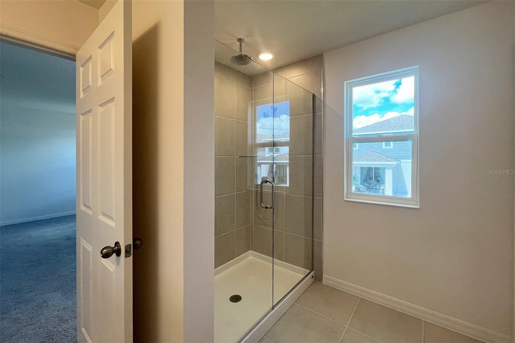 7036 Rolling Leaf Road Groveland, FL 34736 - Photo 11 of 18 a bathroom with a bathtub and shower