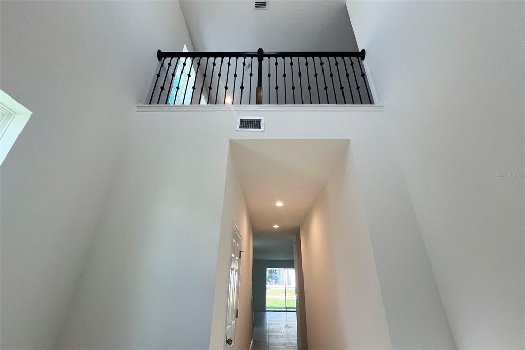 7036 Rolling Leaf Road Groveland, FL 34736 - Photo 2 of 18 a view of staircase with railing and white walls