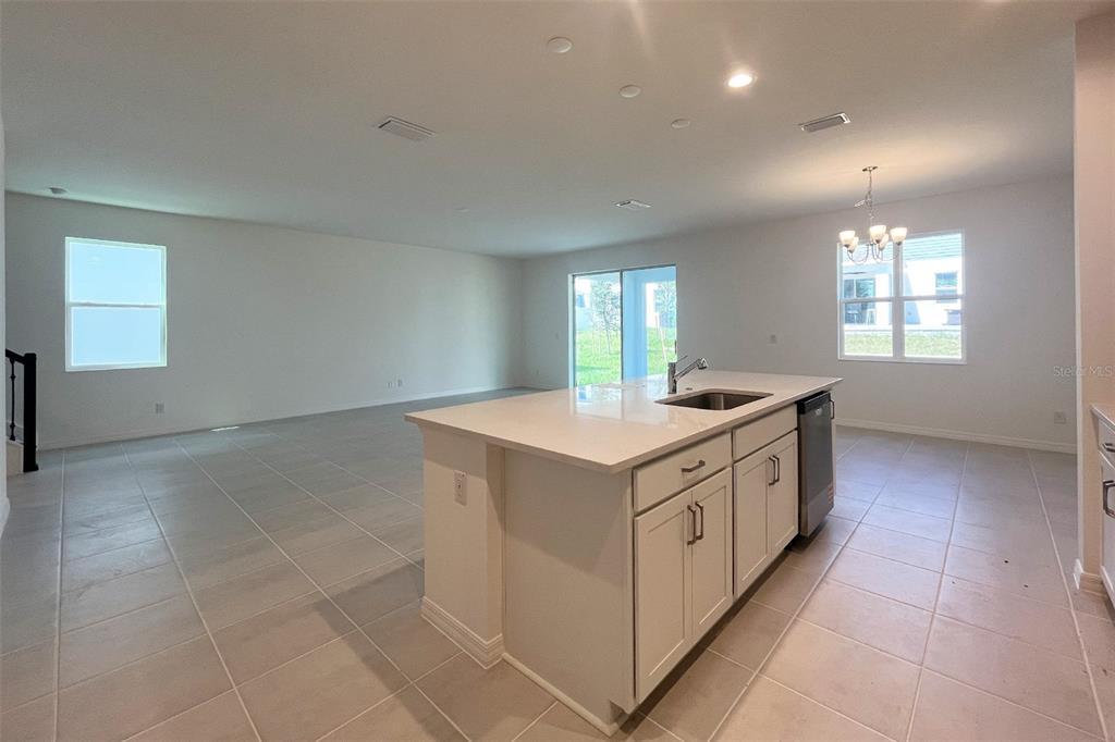 7036 Rolling Leaf Road Groveland, FL 34736 - Photo 4 of 18 a kitchen with a sink and cabinets
