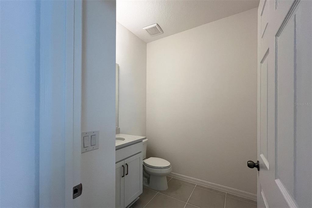 7036 Rolling Leaf Road Groveland, FL 34736 - Photo 9 of 18 a white toilet sitting next to a shower