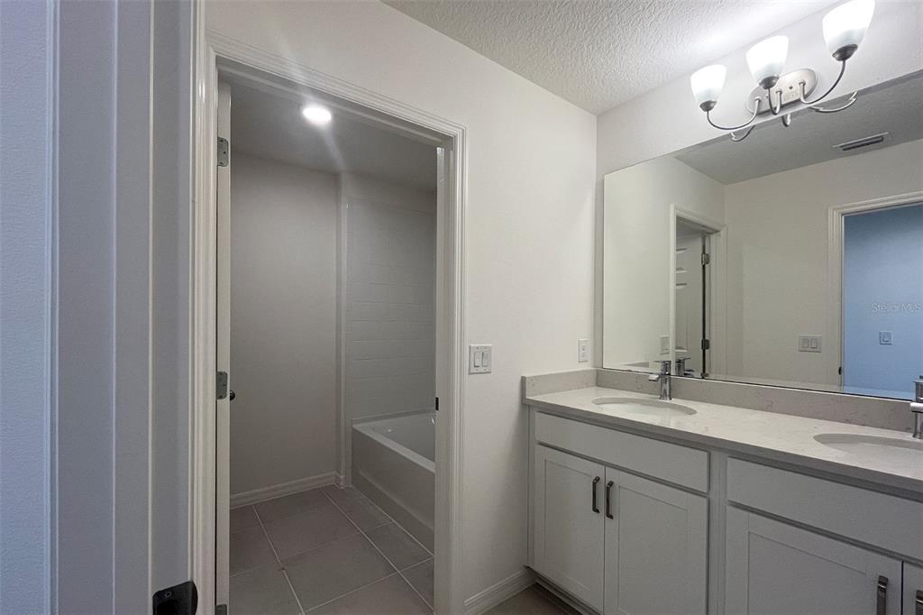 7036 Rolling Leaf Road Groveland, FL 34736 - Photo 10 of 18 a bathroom with a sink a vanity and a mirror