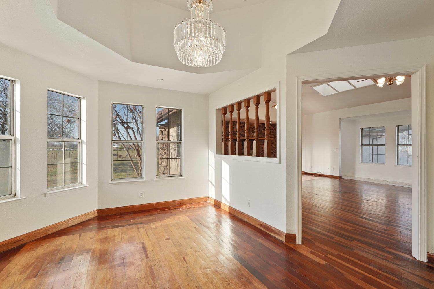 16321 South Wing Levee Road Stockton, CA 95206 - Photo 20 of 71 a view of an empty room with wooden floor and a window