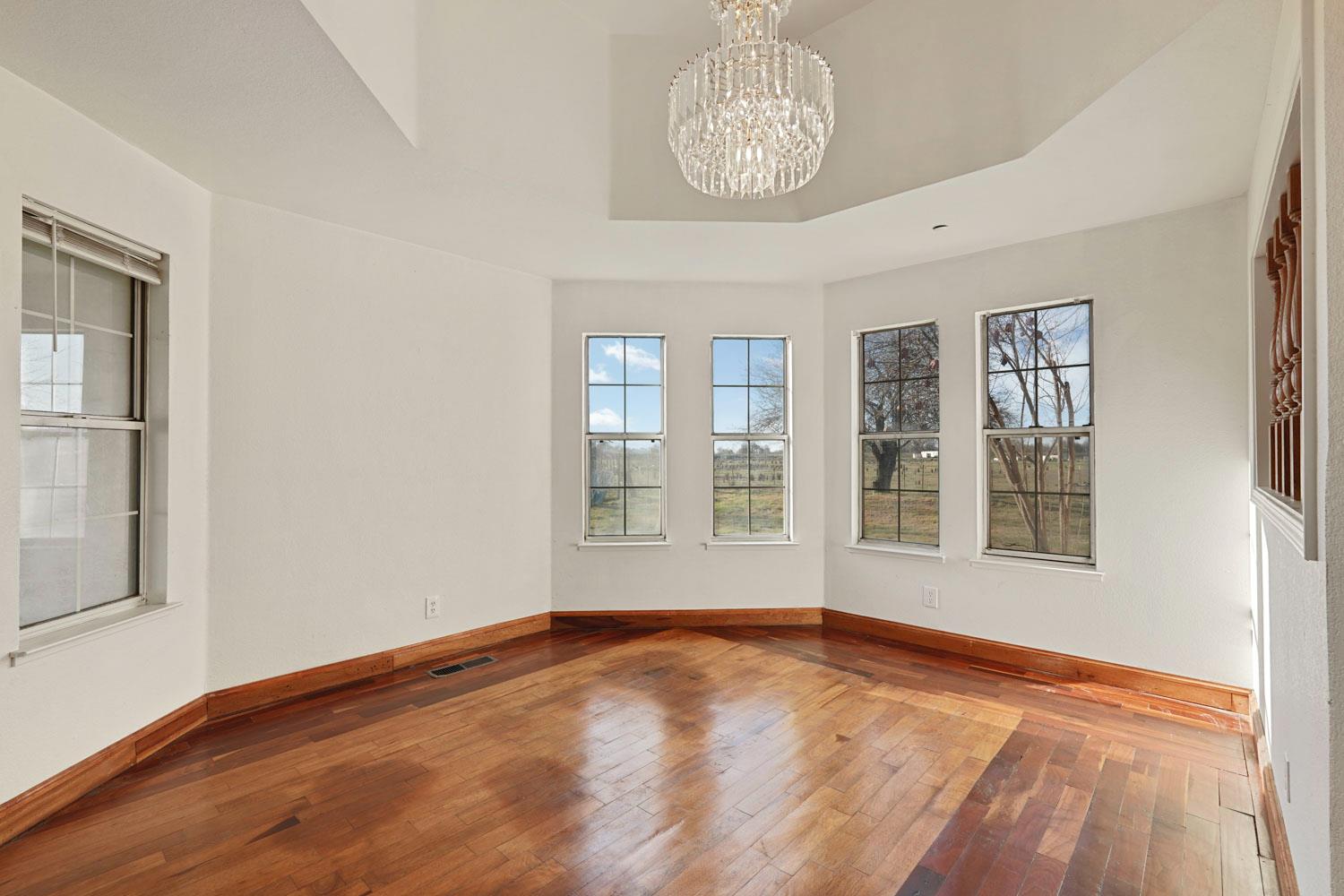 16321 South Wing Levee Road Stockton, CA 95206 - Photo 21 of 71 a view of an empty room with a window and wooden floor