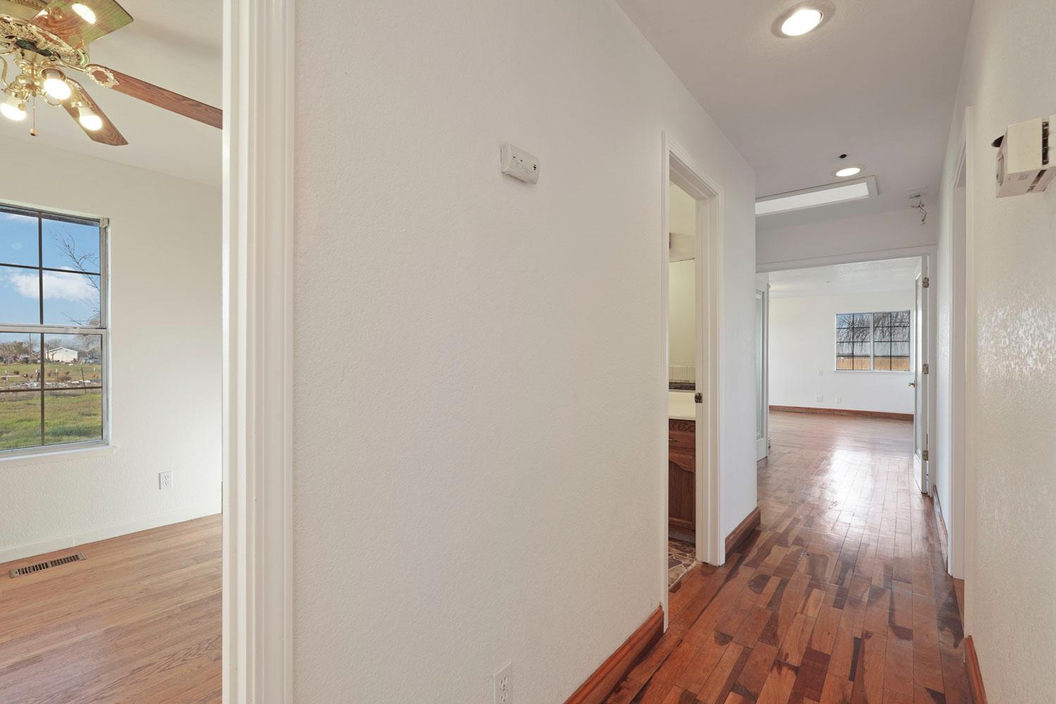 16321 South Wing Levee Road Stockton, CA 95206 - Photo 24 of 71 a view of a hallway with wooden floor and staircase