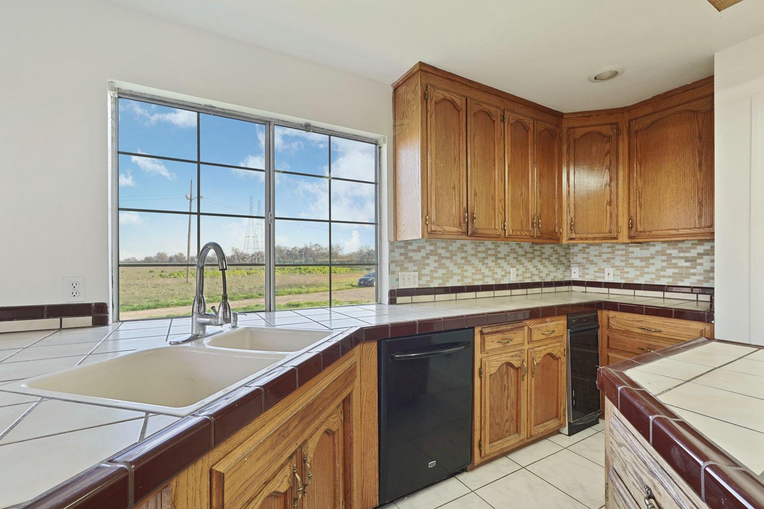 16321 South Wing Levee Road Stockton, CA 95206 - Photo 27 of 71 a kitchen with a sink and large cabinets