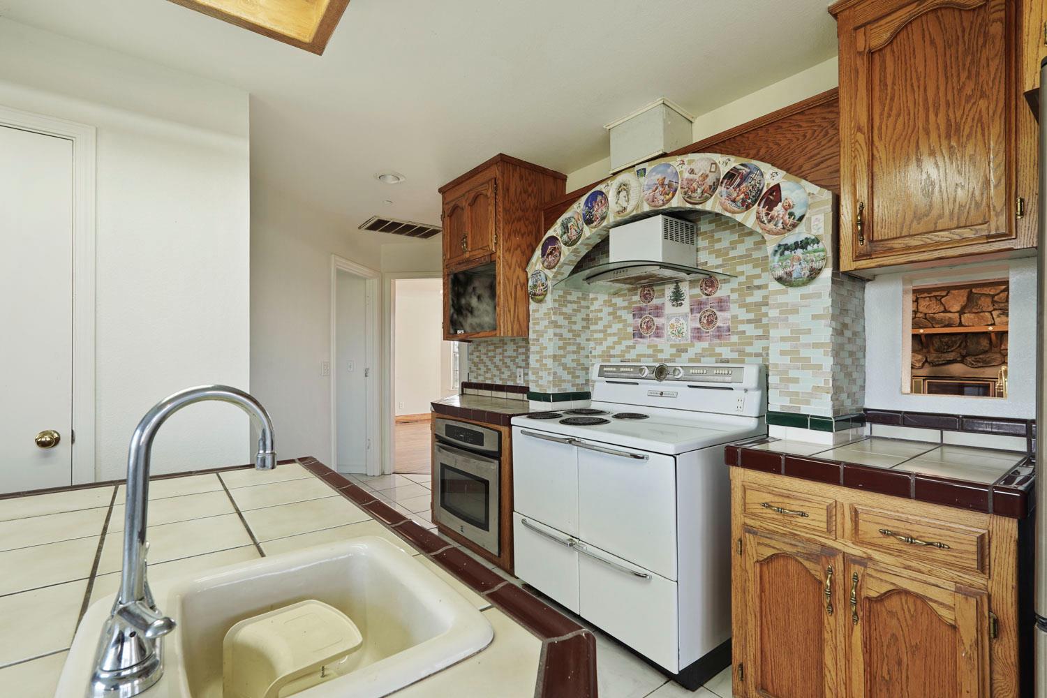 16321 South Wing Levee Road Stockton, CA 95206 - Photo 28 of 71 a kitchen with a stove microwave and sink
