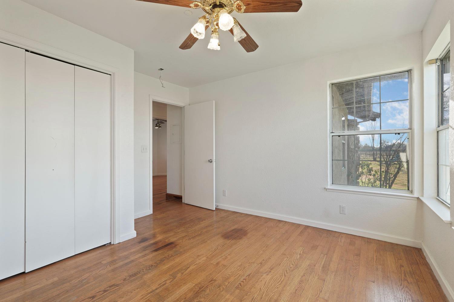 16321 South Wing Levee Road Stockton, CA 95206 - Photo 34 of 71 a view of an empty room with wooden floor and a window
