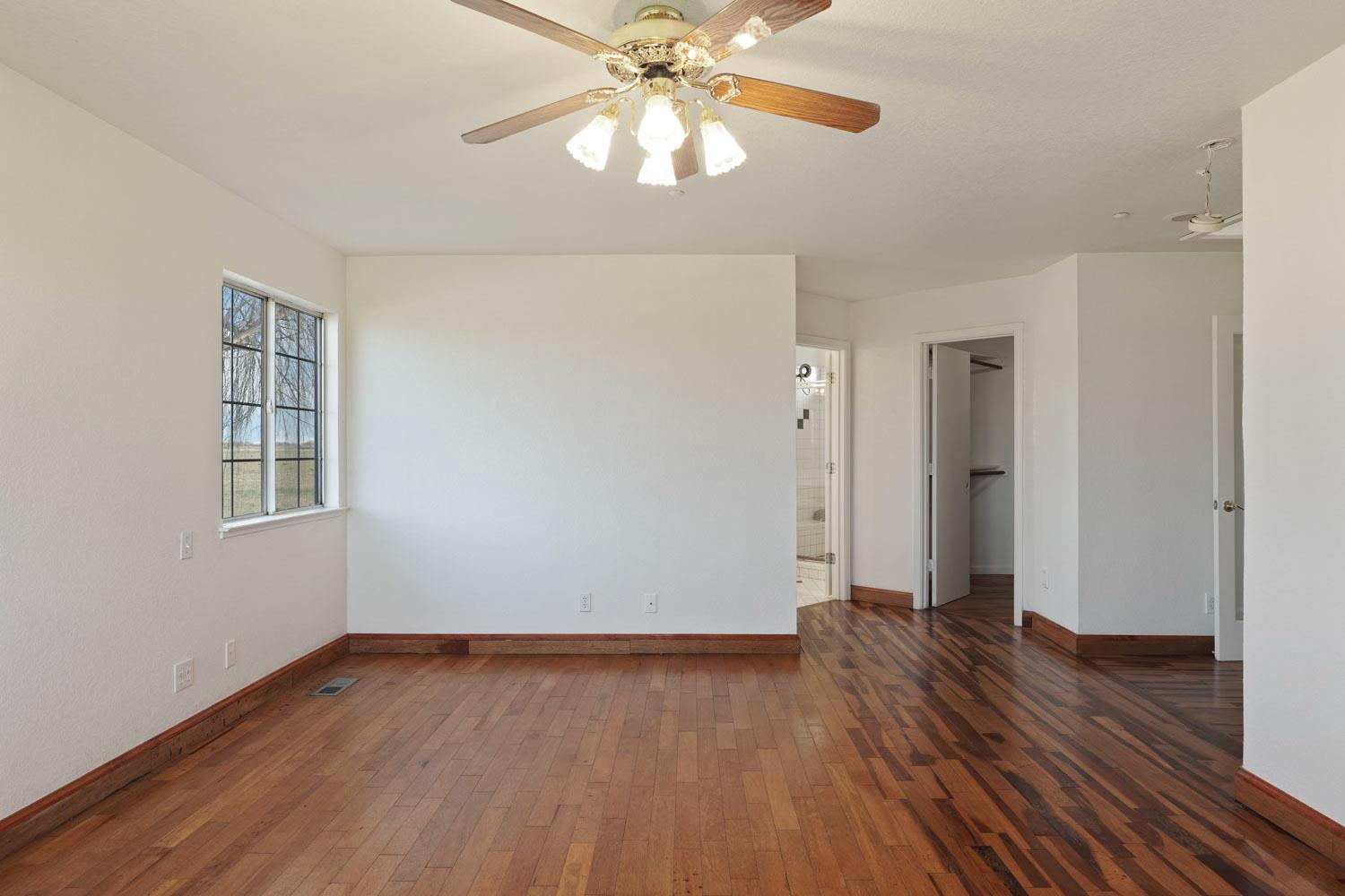 16321 South Wing Levee Road Stockton, CA 95206 - Photo 38 of 71 a view of an empty room with wooden floor and a window