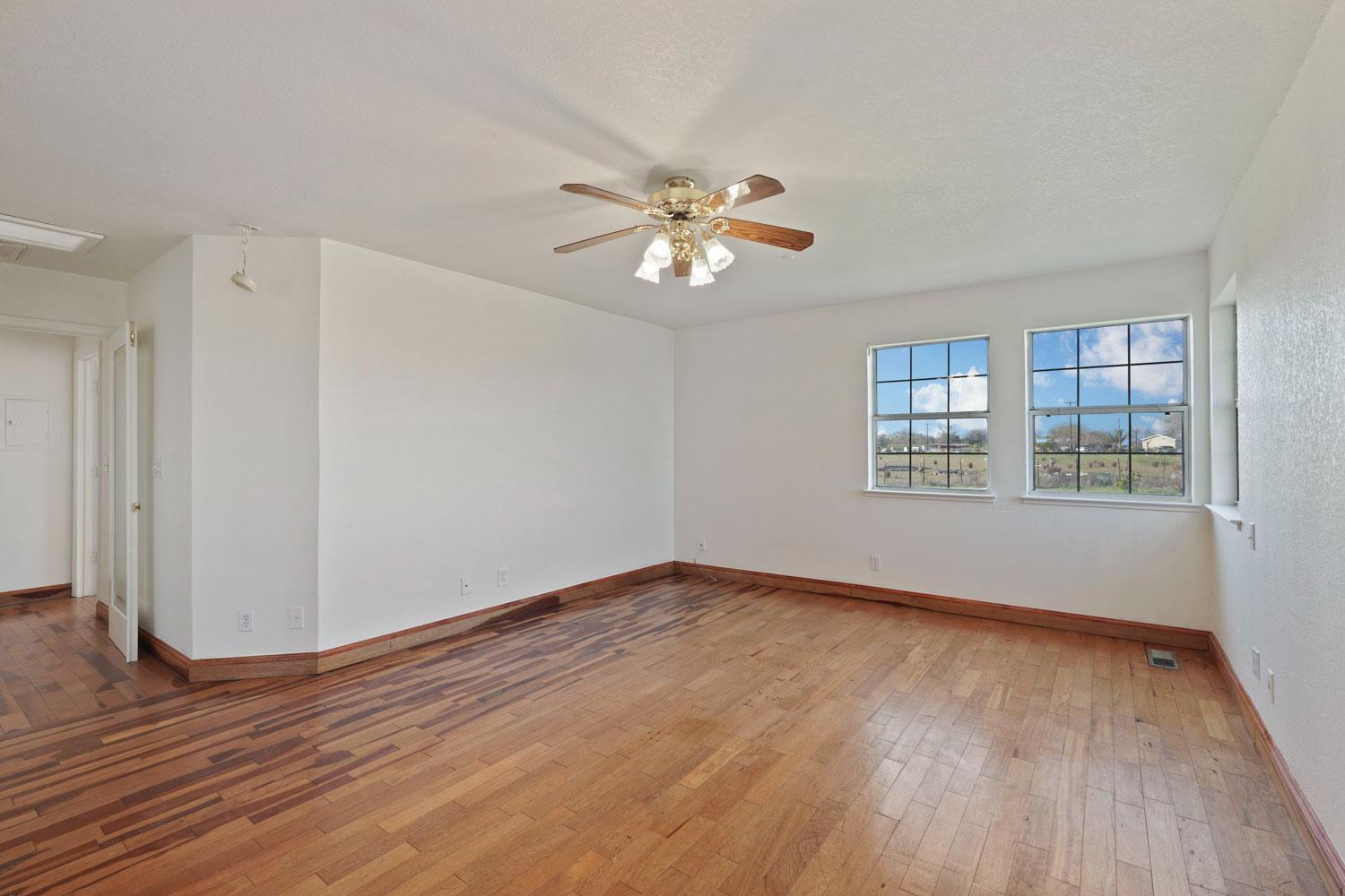 16321 South Wing Levee Road Stockton, CA 95206 - Photo 39 of 71 wooden floor in an empty room with a window