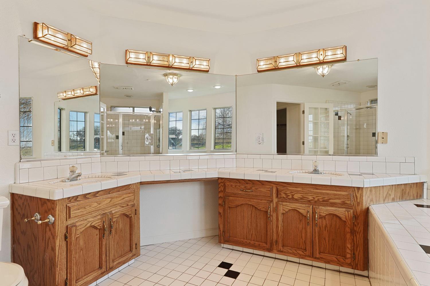 16321 South Wing Levee Road Stockton, CA 95206 - Photo 41 of 71 a bathroom with a sink double vanity and a mirror